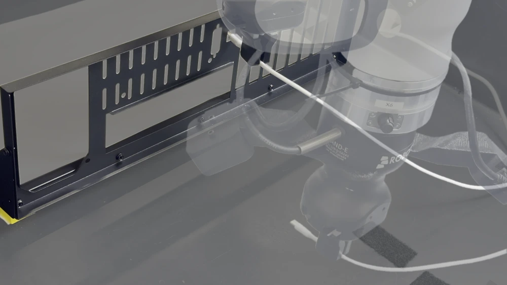 A sequence of robot poses inserting a USB-C cable through a narrow opening in a computer case panel.